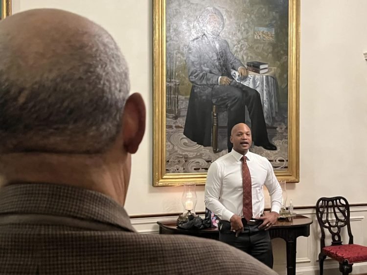 Over the shoulder of Senior Journalist Charles Robinson of MPT as he listens to Gov. Wes Moore yesterday at Government House, where the Governor lives with his family.
