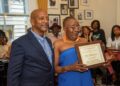Ms. Peaches is honored with a Joe Manns Black Wall Street Award for her service,