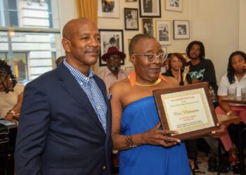 Ms. Peaches is honored with a Joe Manns Black Wall Street Award for her service,