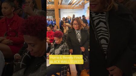 Nicole Kirby presents Joe Manns Black Wall Street Award to her parents.